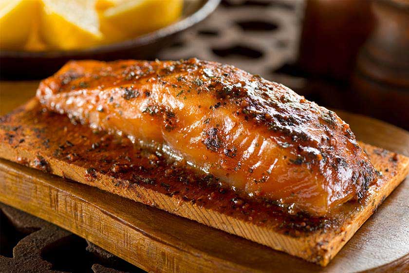 Baked Salmon fillet with a tarragon mustard glaze on a cedar grilling plank