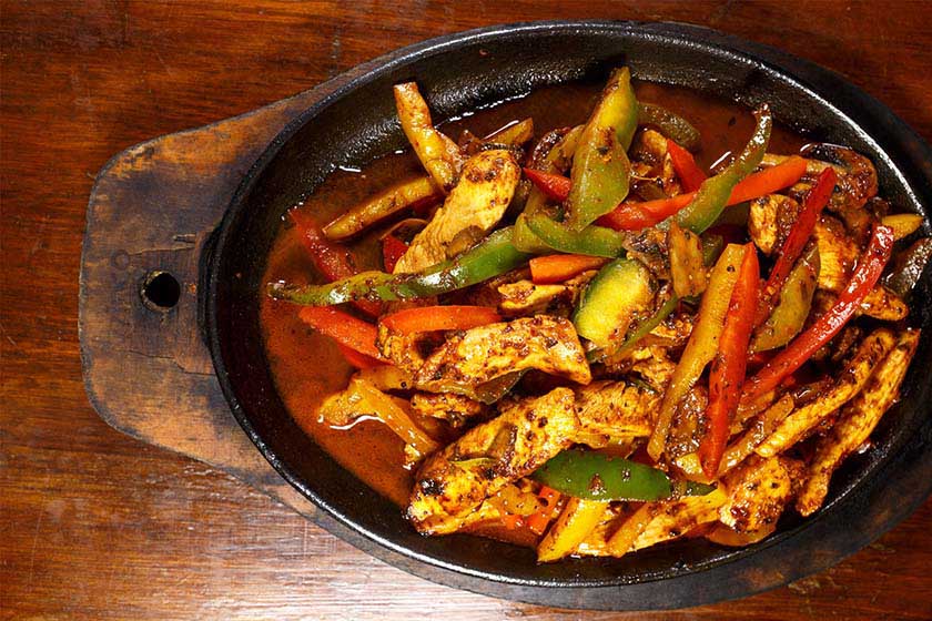 Chicken Fajitas with colorful peppers in a iron skillet