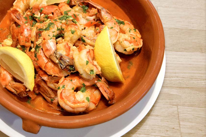 Bowl of traditional Spanish Gambas a Ajillo with shrimp, garlic, and smoked paprika