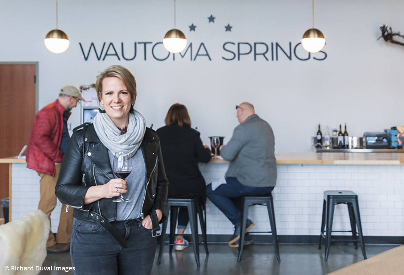 Wautoma Springs owner and winemaker, Jessica Munnell smiling in her tasting room
