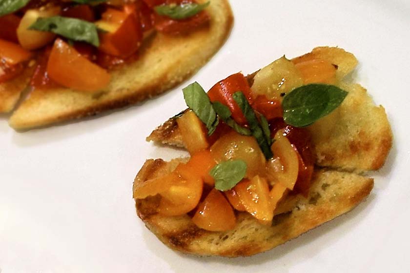Close-up of tomato bruschetta topped with basil