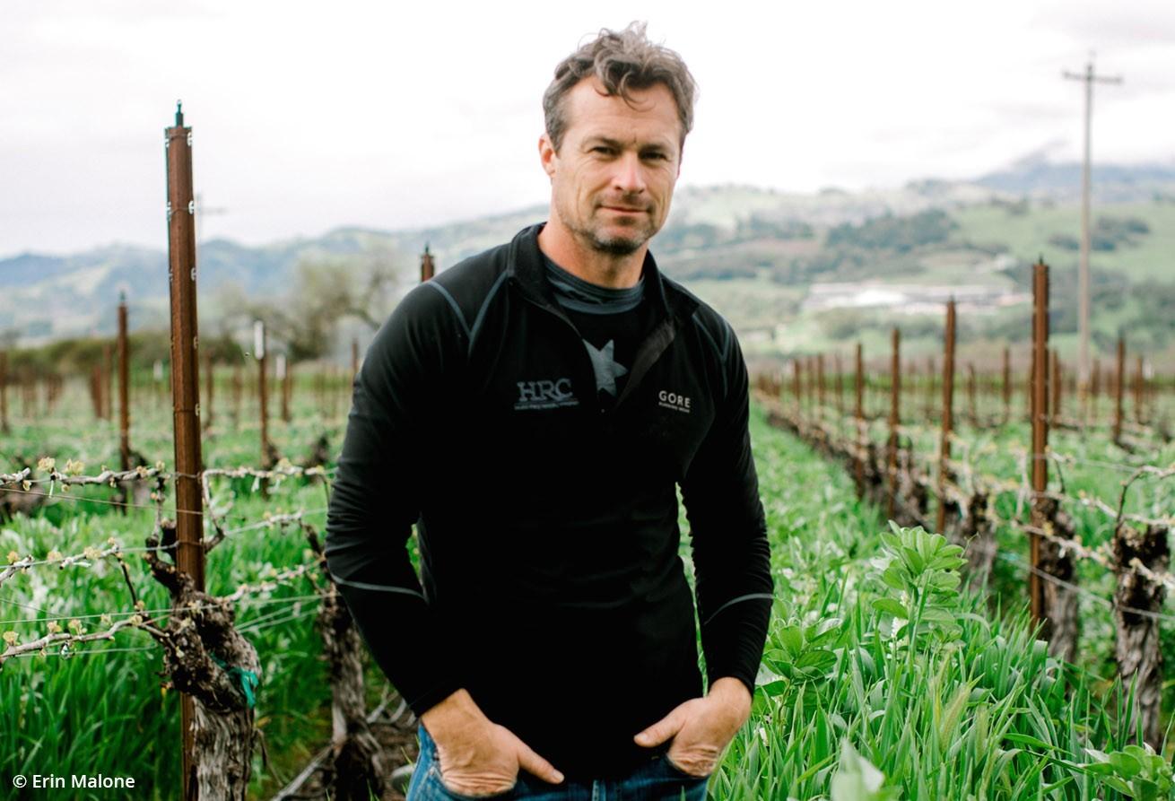 Leo Steen winemaker, Leo Hansen, in a lush green California vineyard
