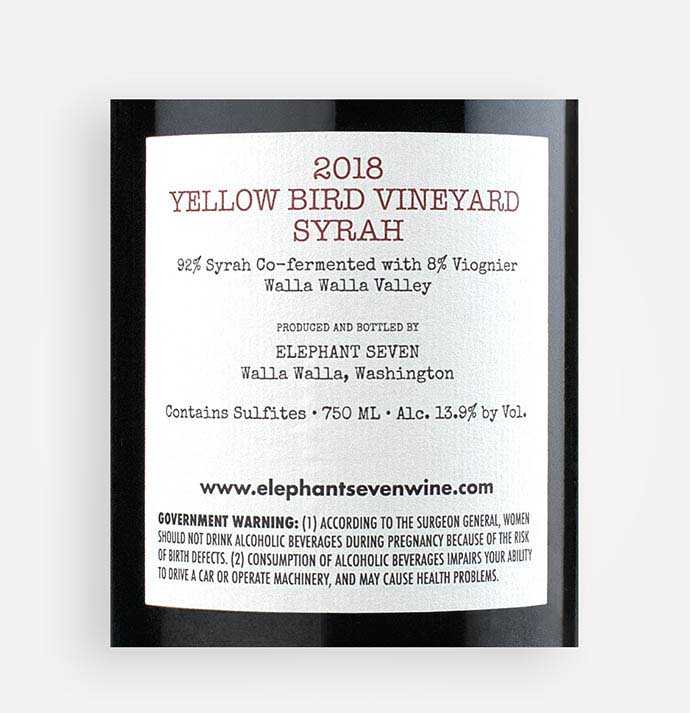 Back label close-up of Elephant Seven 2018 Yellow Bird Vineyard Syrah wine from Washington's Walla Walla Valley