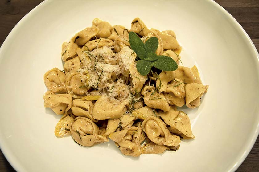 Pumpkin tortellini with brown butter and garnished with sage