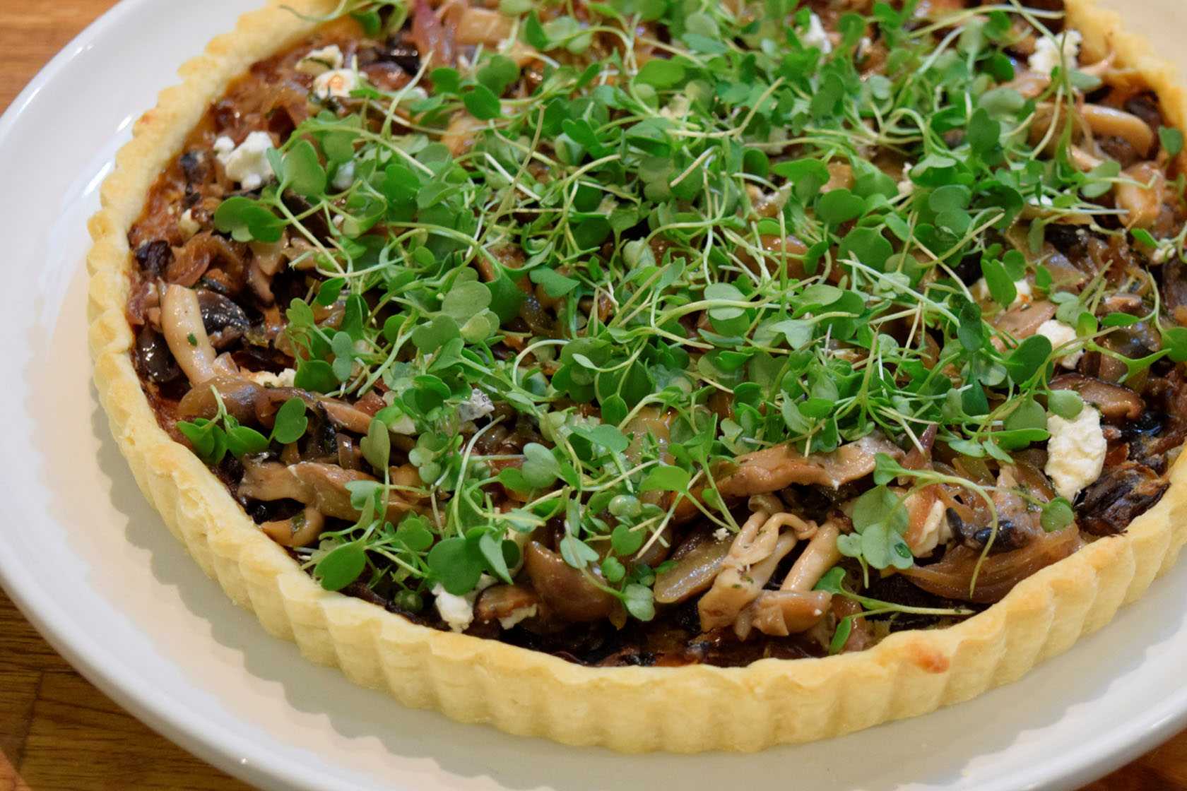 Mushroom and goat cheese torte topped with arugula