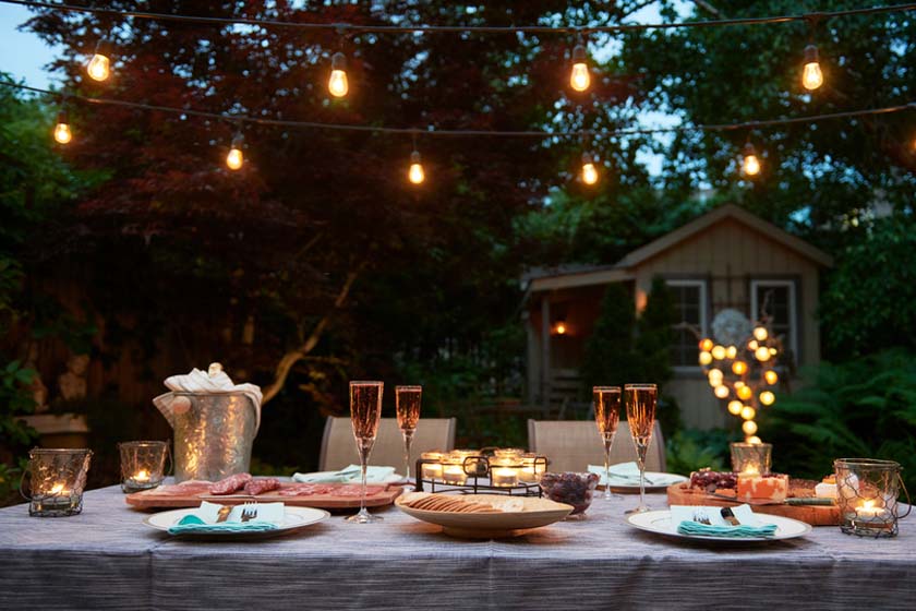 Backyard summer party with wine and twinkle lights