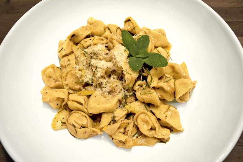 Pumpkin tortellini with brown butter and garnished with sage